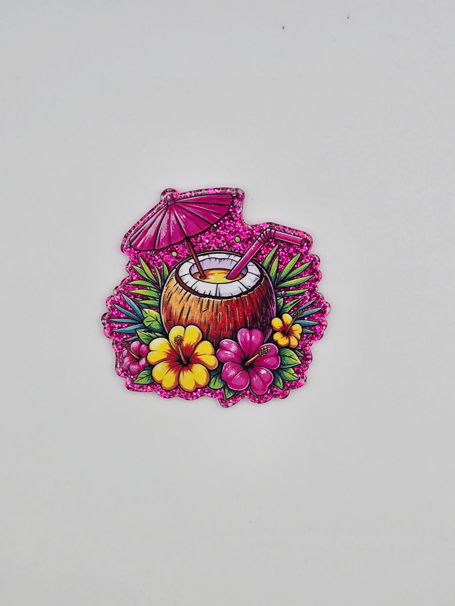 Decorative flatback with floral design and coconut in the middle on a pink background