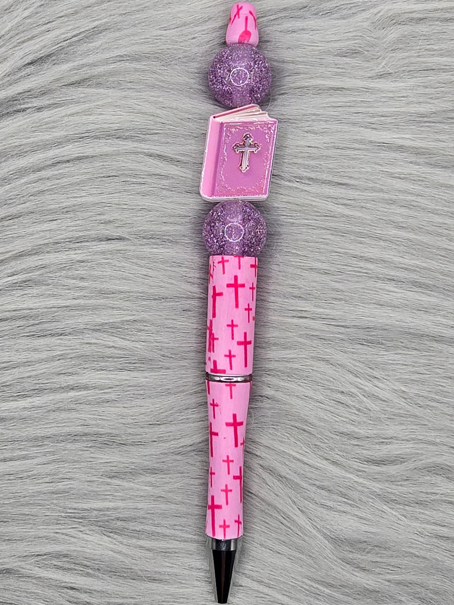 Pink beadabale pen with dark pink crosses with a pink bible with a silver cross and 2 glitter purple beads