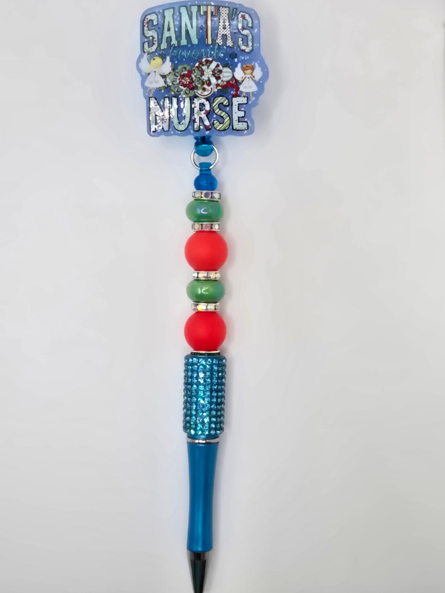 Decorative pen with beads and a flatback that says Santa's Favorite Nurse