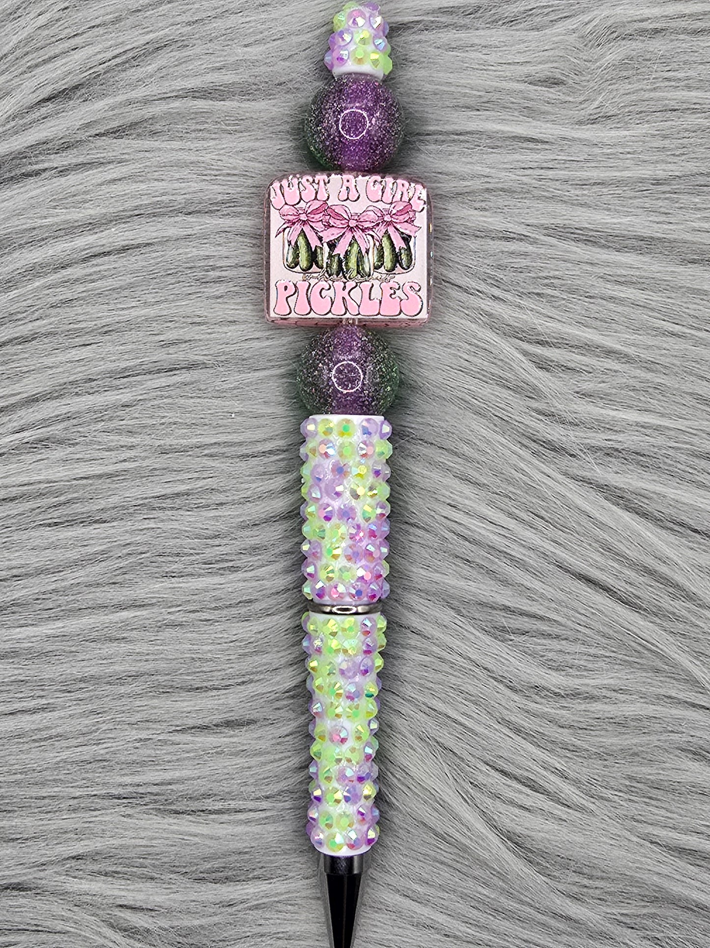 Beadable green and purple rhinestone pen. Acrylic focal that says "Just A Girl Who Loves Pickles" and 2 beads that are half purple/half green