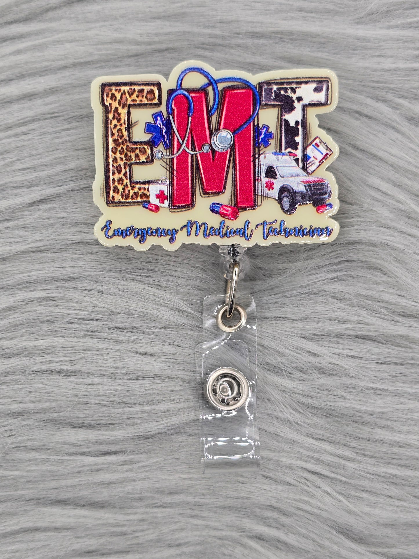 Medical-themed acrylic flatback with 'Emergency Medical Technician' text on the bottom and EMT in the middle on a light yellow background