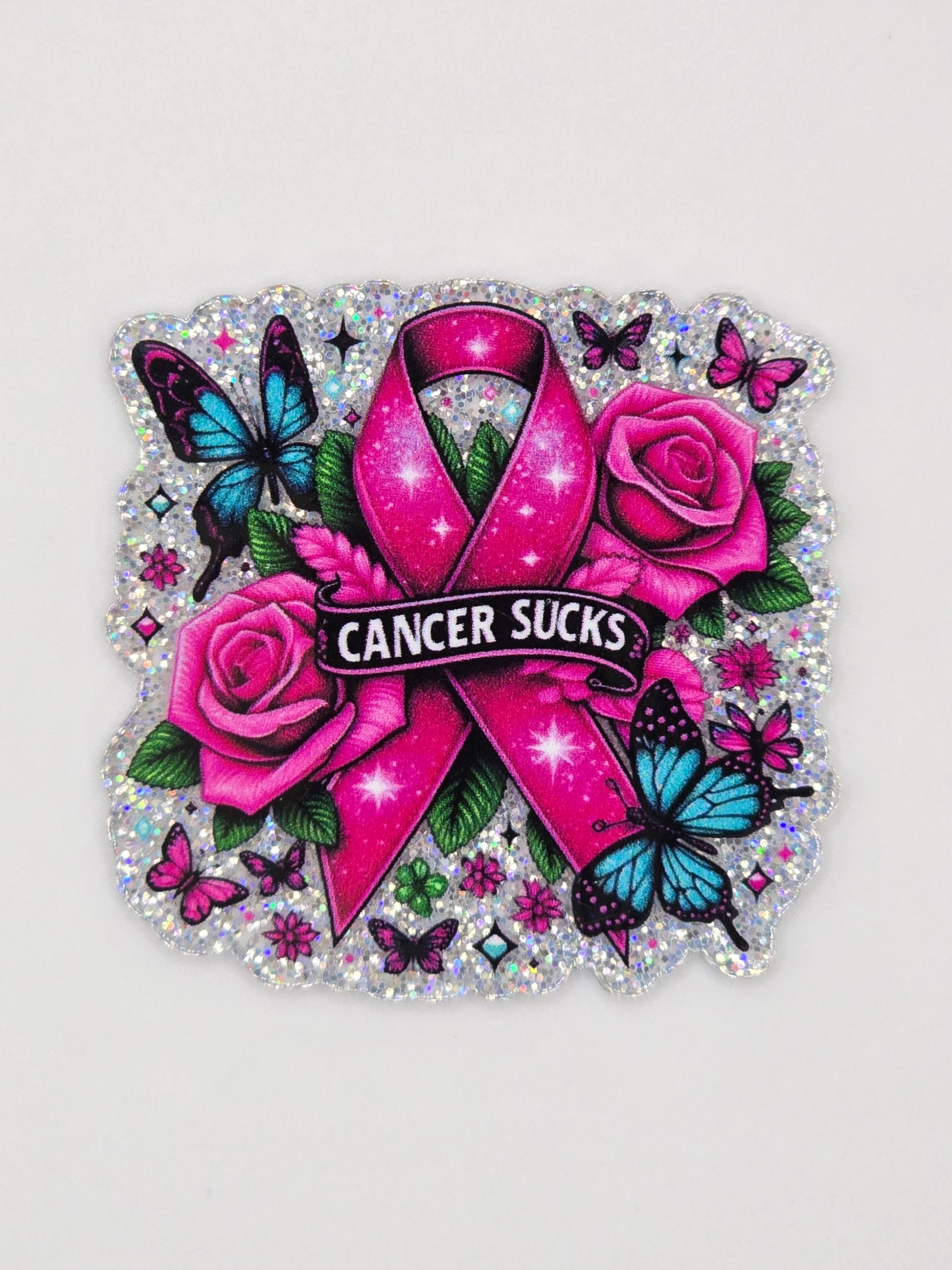 Pink ribbon acrylic flatback with 'Cancer Sucks' text surrounded by roses and butterflies on a white background