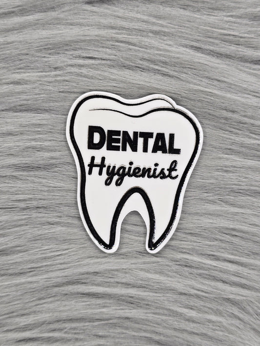 White Acrylic flatback in the shape of a tooth that says 'Dental Hygienist' in black 