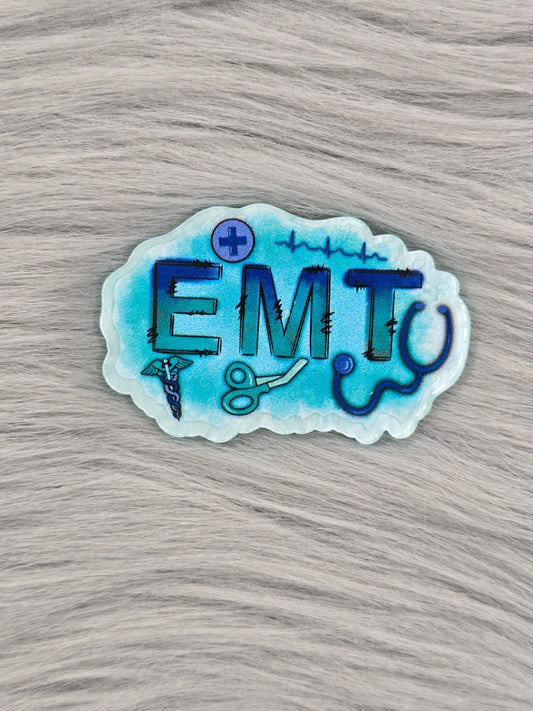 Blue/White acrylic flatback with the letters 'EMT' with medical pictures