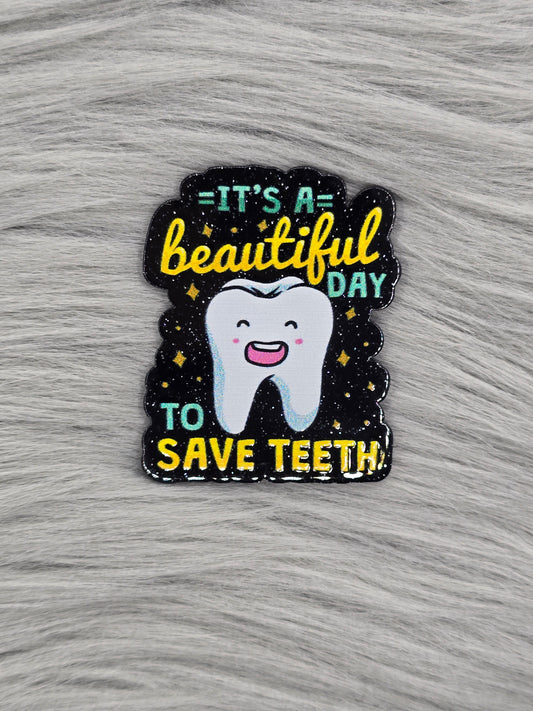 Black glitter acrylic flatback with the words "It's A Beautiful Day To Save Teeth" in green and yellow with a tooth in the middle