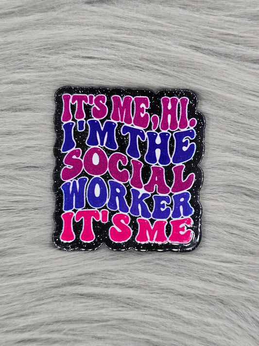 Acrylic flatback with glitter black background and the words 'It's Me, Hi I'm The Social Worker It's Me' in pink and blue