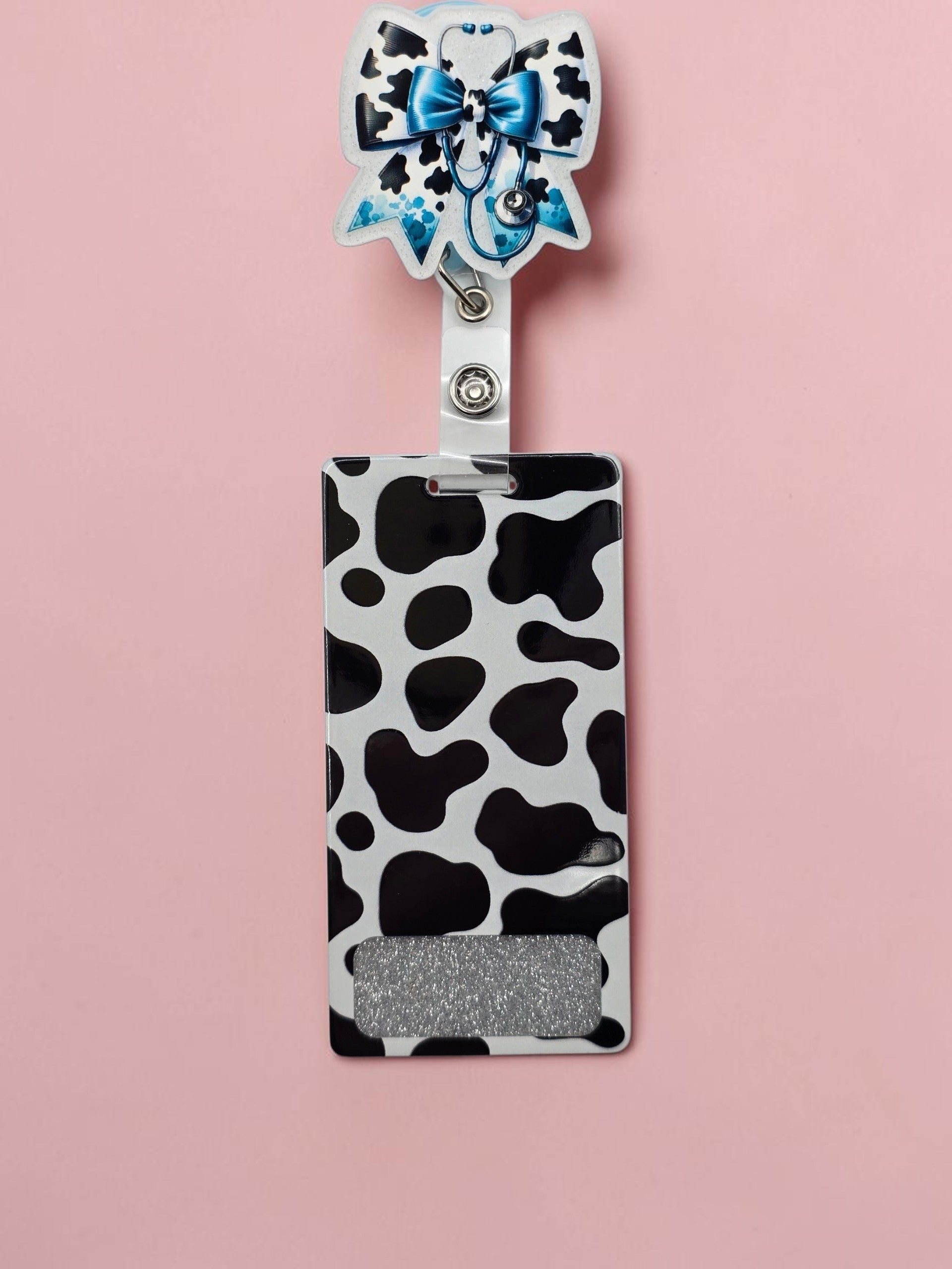 Black/White/Blue printed Cow Bow flatback with stethoscope with a Black/white long cow printed badge buddy