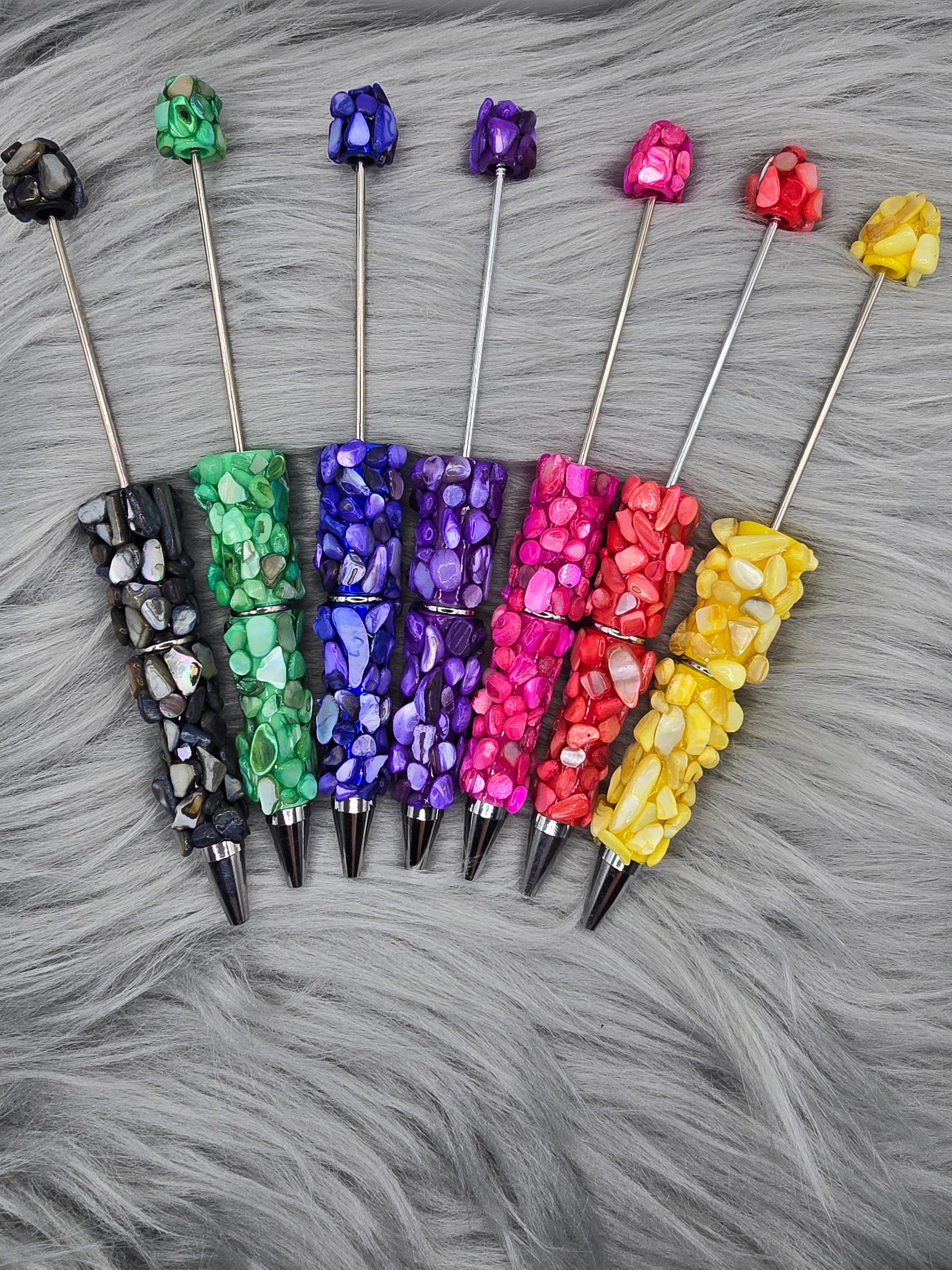 Beadable pen in black, green, blue, purple,pink, red and yellow with small stones on them