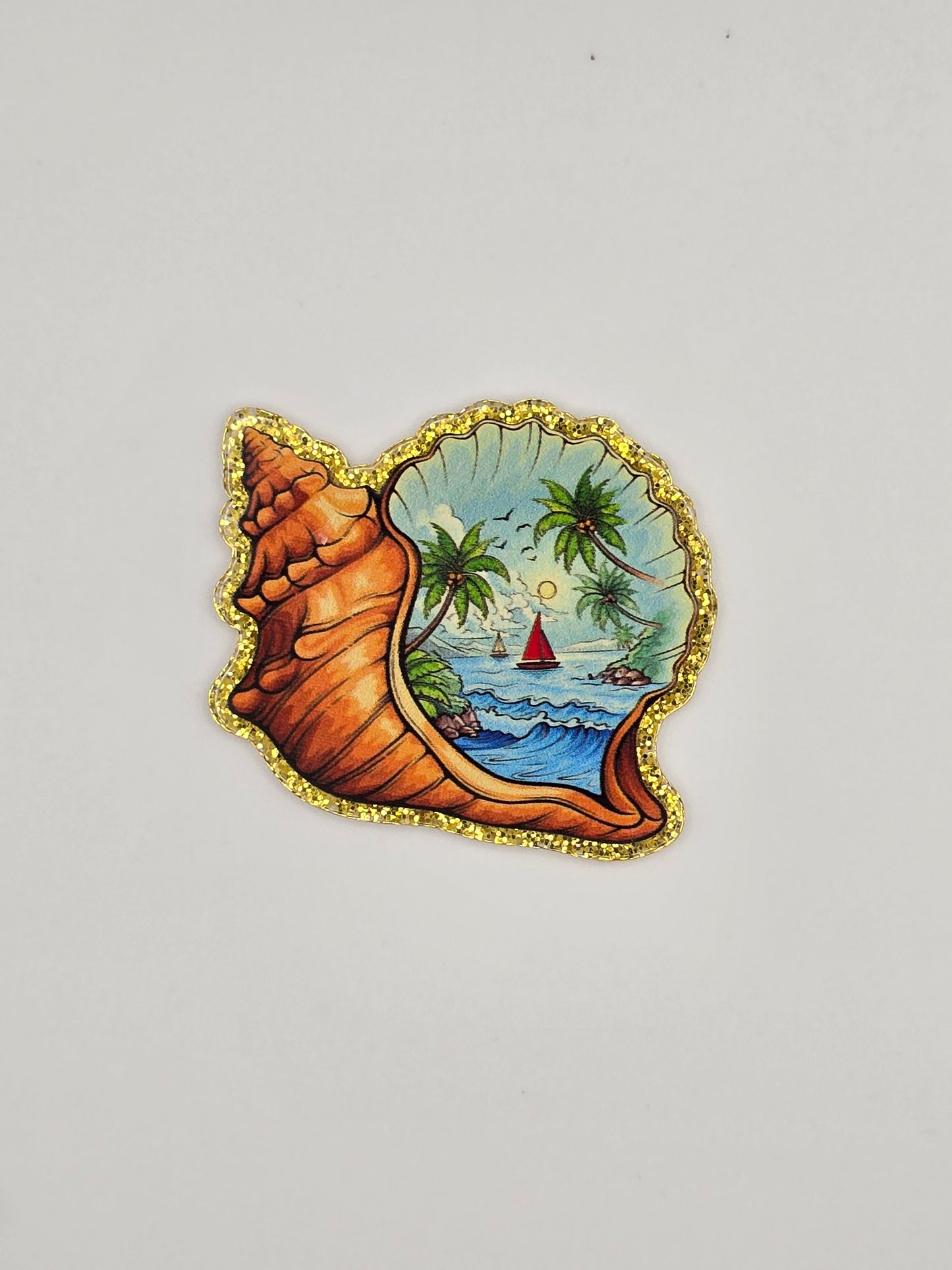 Decorative shell-shaped flatback with a Island/ ocean scenic design 