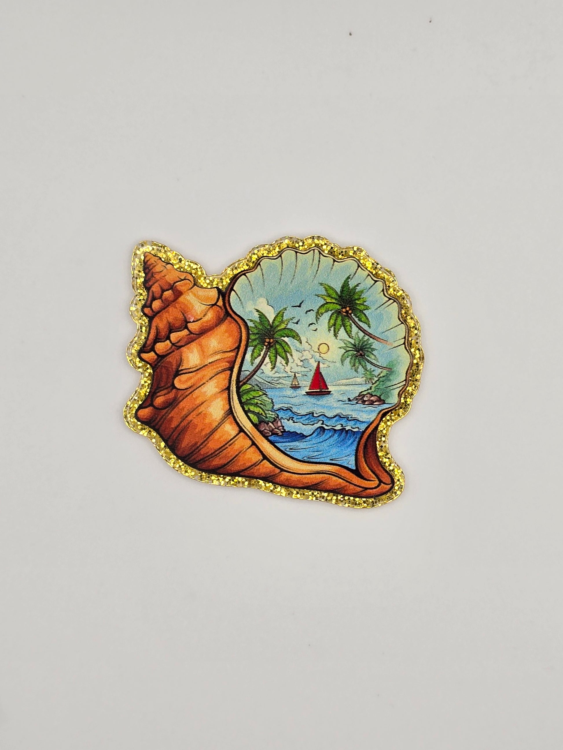 Decorative shell-shaped flatback with a Island/ ocean scenic design 