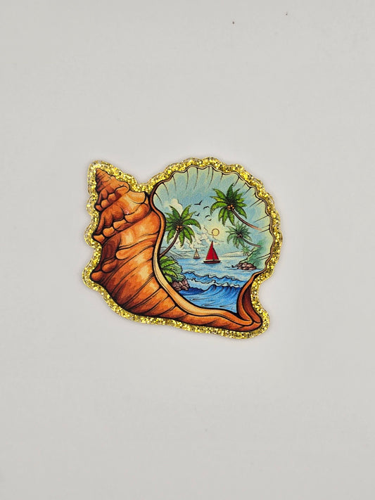 Decorative shell-shaped flatback with a Island/ ocean scenic design 