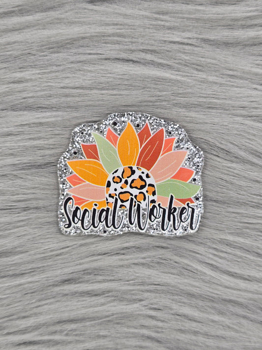 Silver glitter acrylic flatback with a half flower and the bottom says 'Social Worker' in black