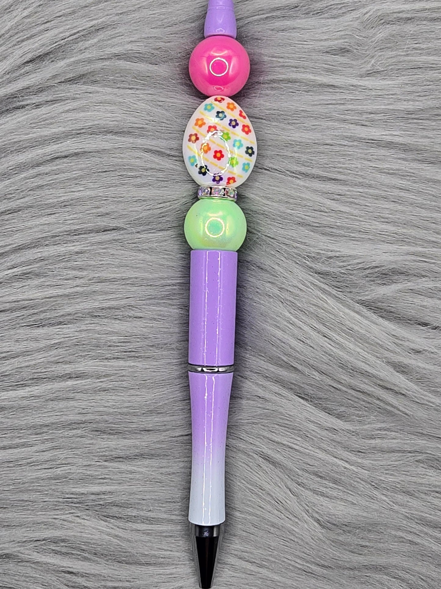 ombre purple beadabale pen with a white acrylic egg focal with flowers and a light green and pink bead