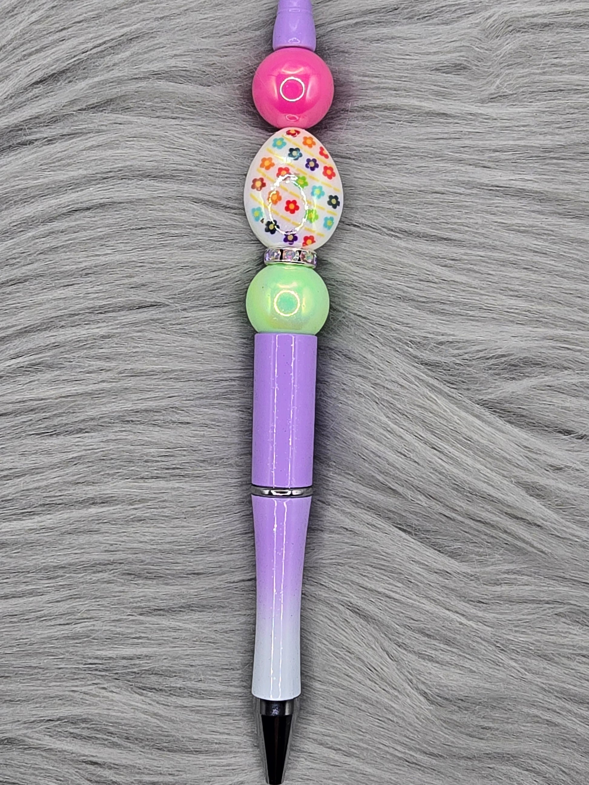 ombre purple beadabale pen with a white acrylic egg focal with flowers and a light green and pink bead