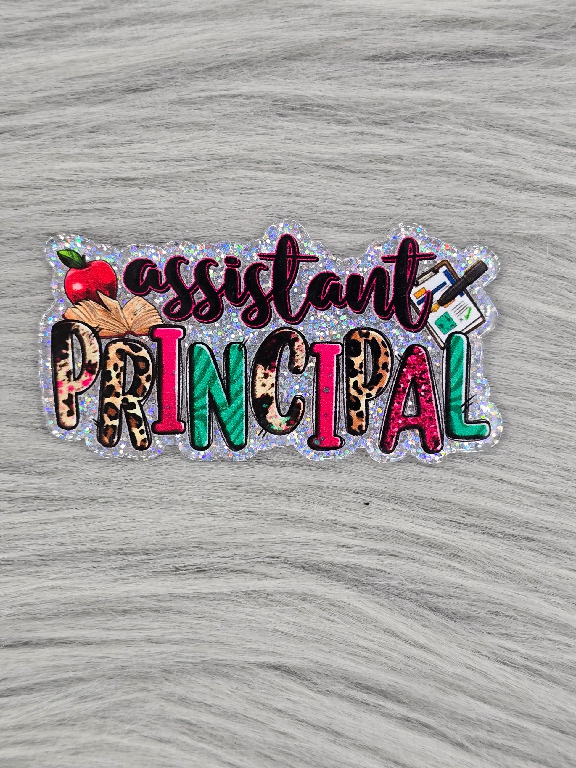 Glitter silver background with the words "assistant PRINCIPAL" Has images of an apple, book and clipboard