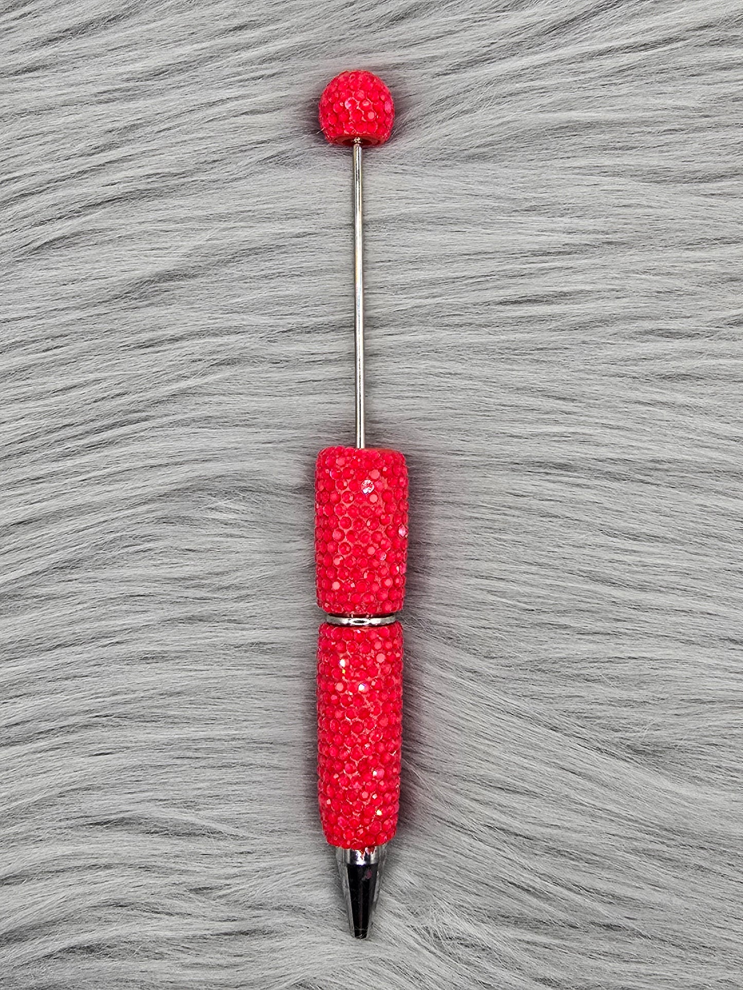 Neon Red beadable pen on gray fur background