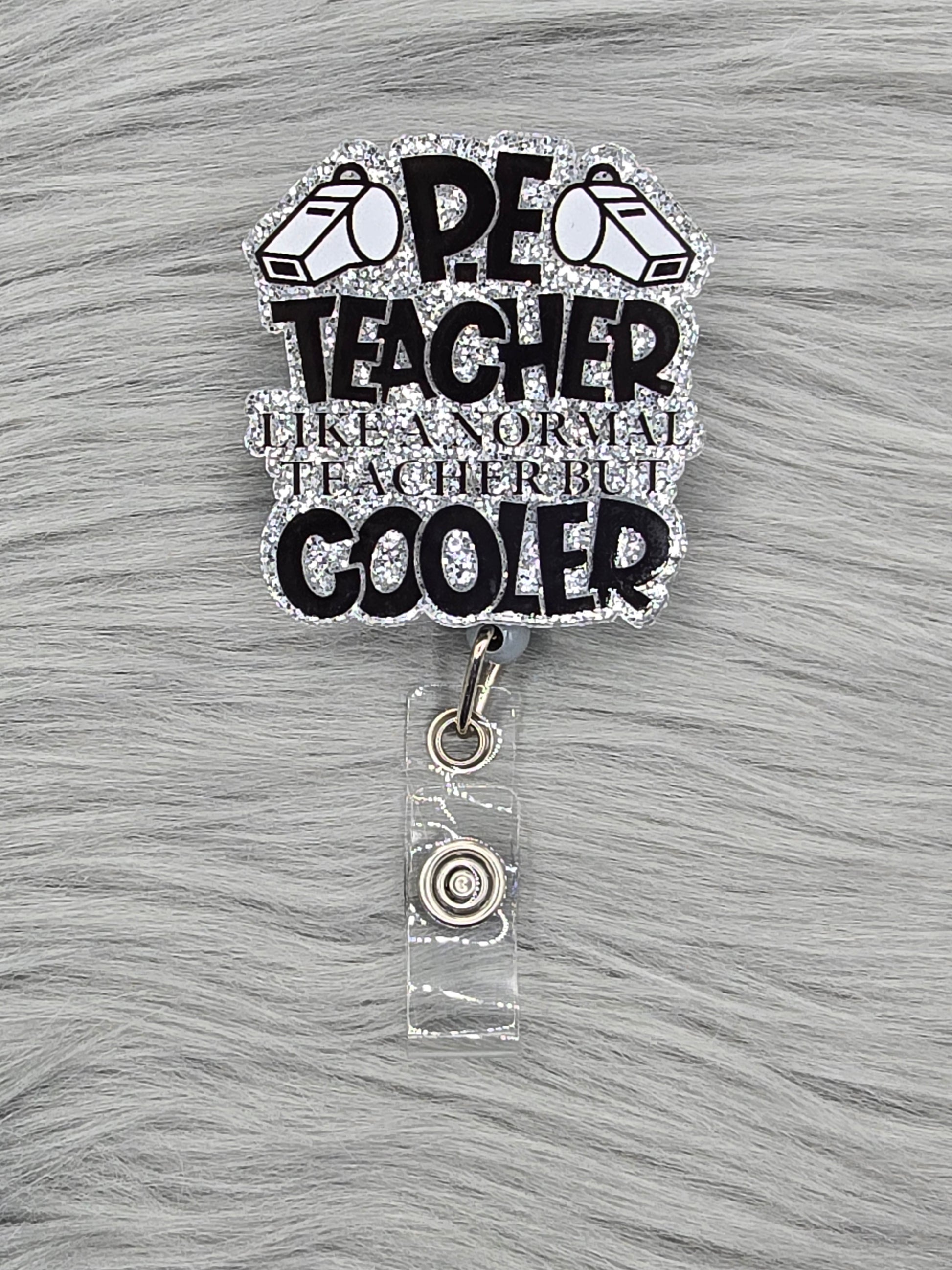 Acrylic flatback says PE Teacher like a normal teacher but cooler on a silver background
