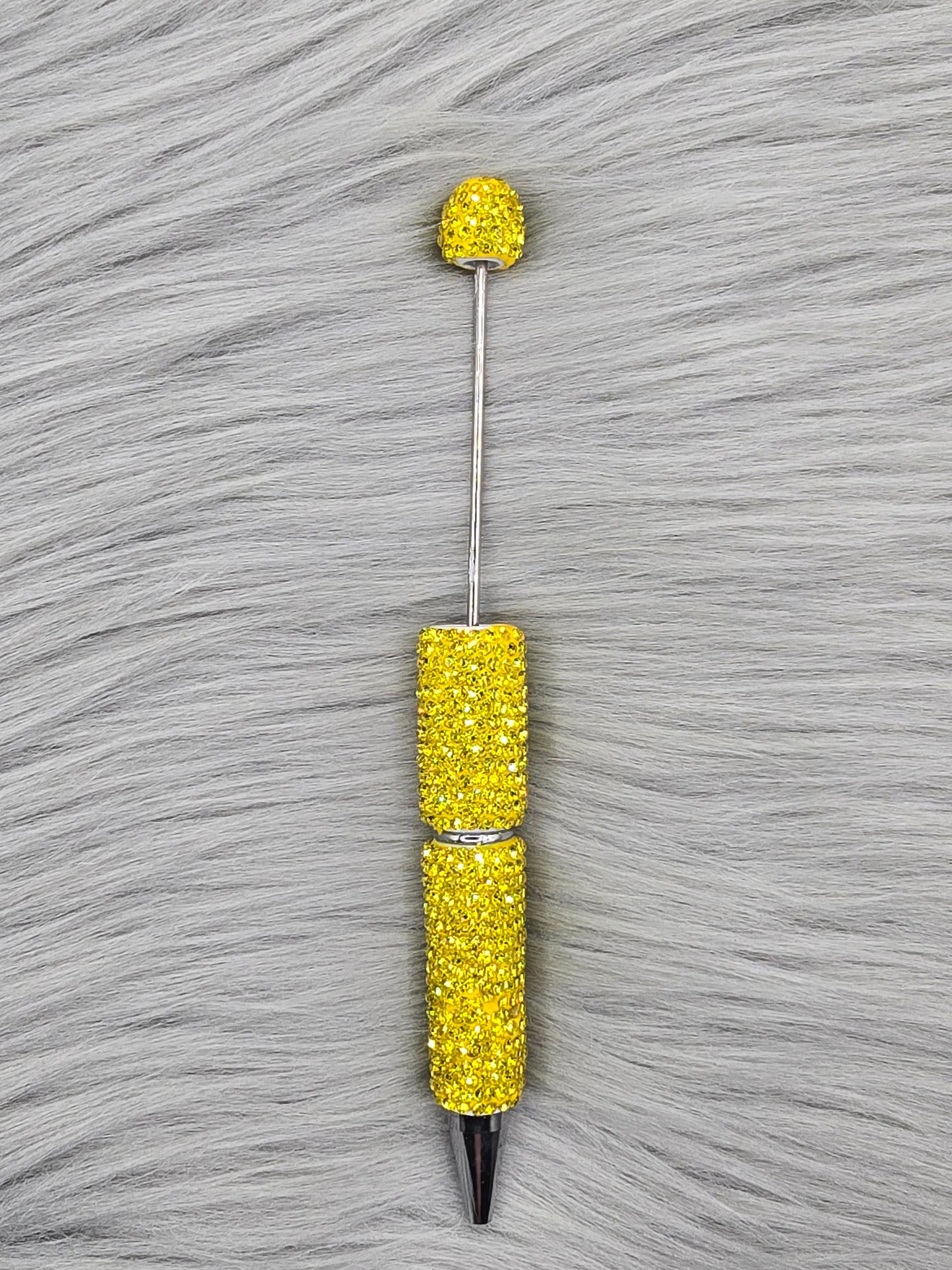 Yellow Clay Rhinestone Beadable Pen on a gray fur background