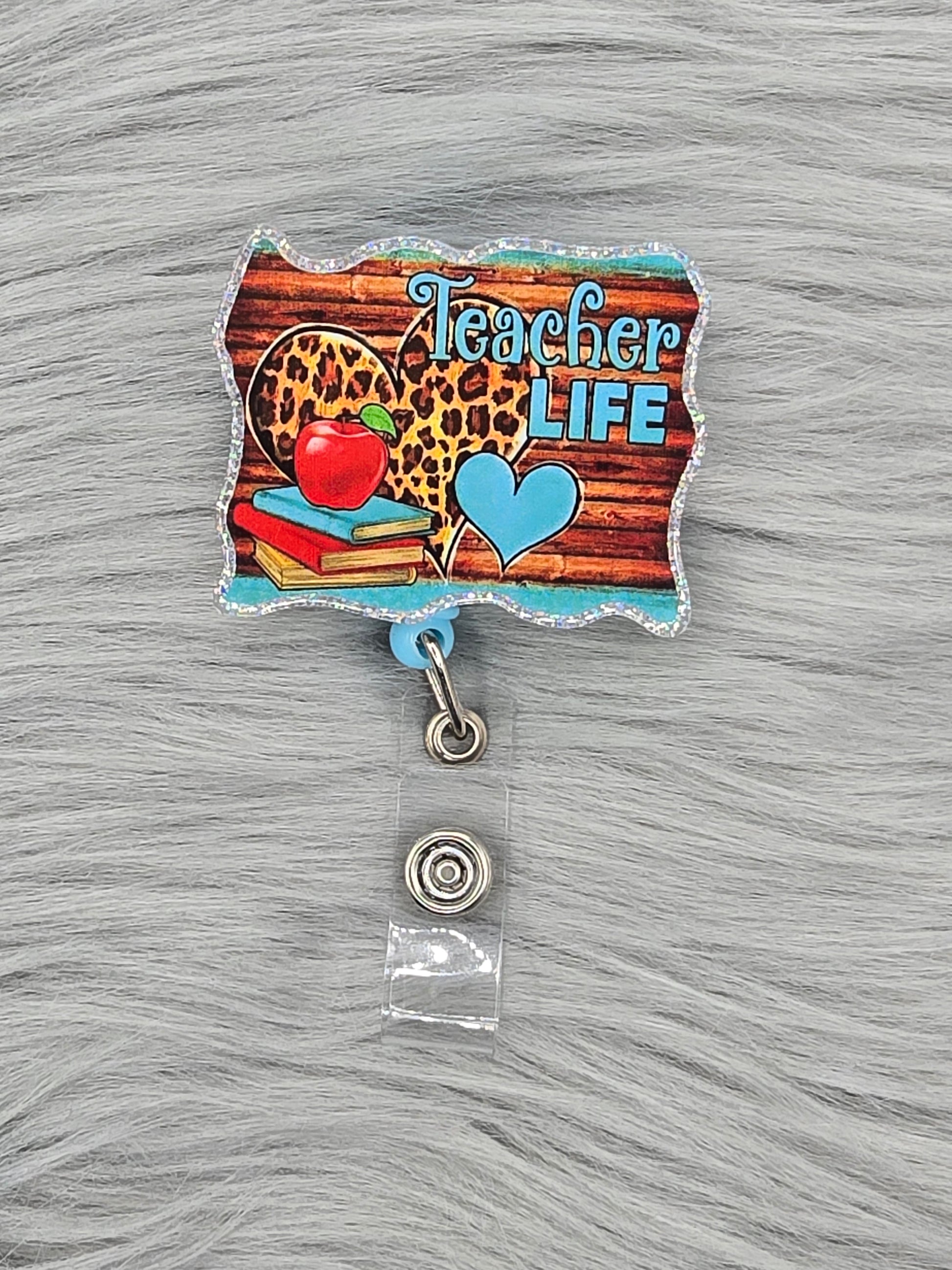 Acrylic flatback with the words Teacher Life on a wood background with hearts, red apple and books