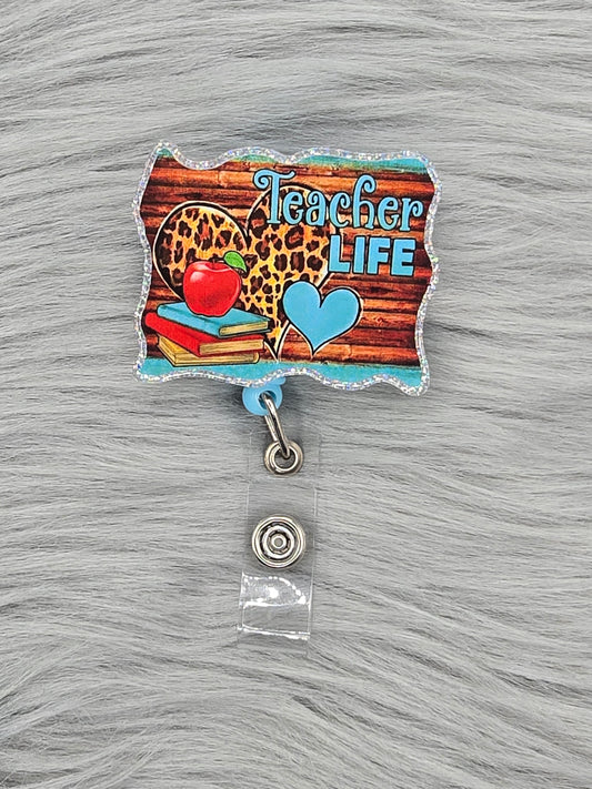 Acrylic flatback with the words Teacher Life on a wood background with hearts, red apple and books