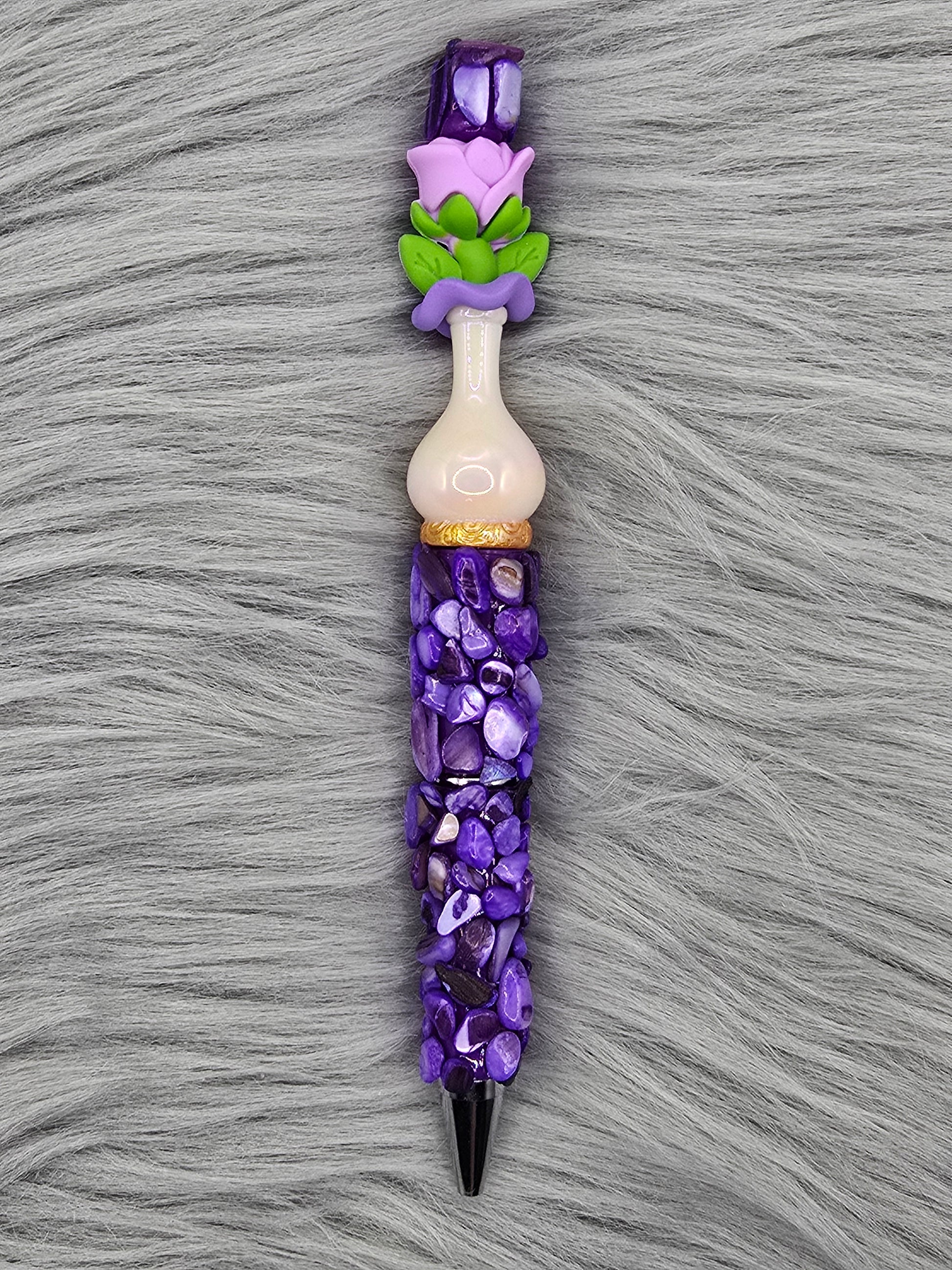 Beadable purple pen with purple pebbles and a white vase focal with a purple flower at the top