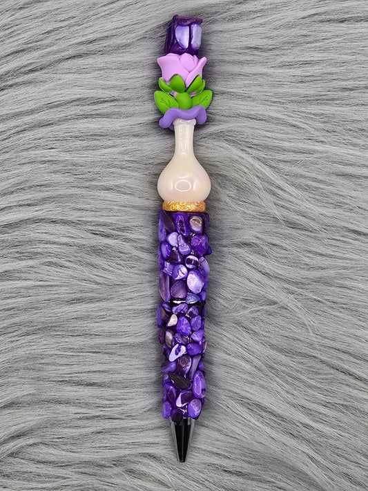 Beadable purple pen with purple pebbles and a white vase focal with a purple flower at the top