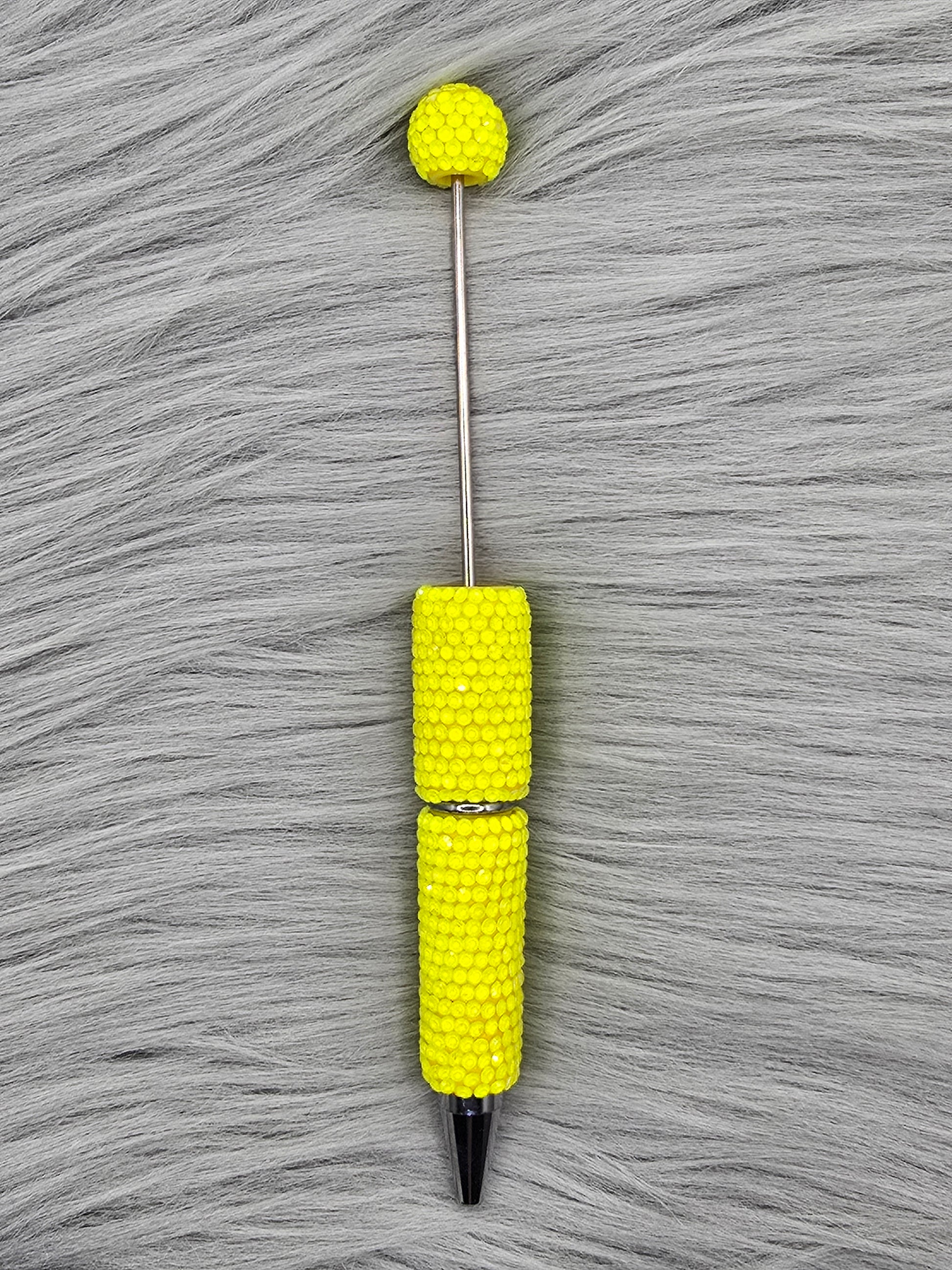 Neon Yellow beadable pen on gray fur background
