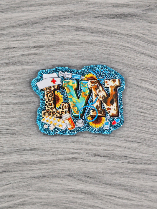 Glitter Blue flatback with the letters "LVN" with pictures of medical supplies