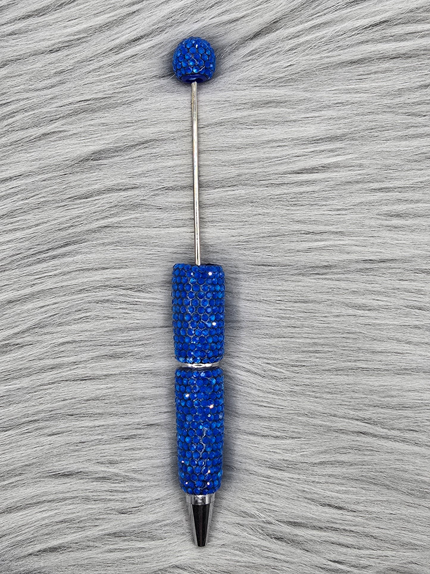 Neon Blue beadable pen on gray fur background