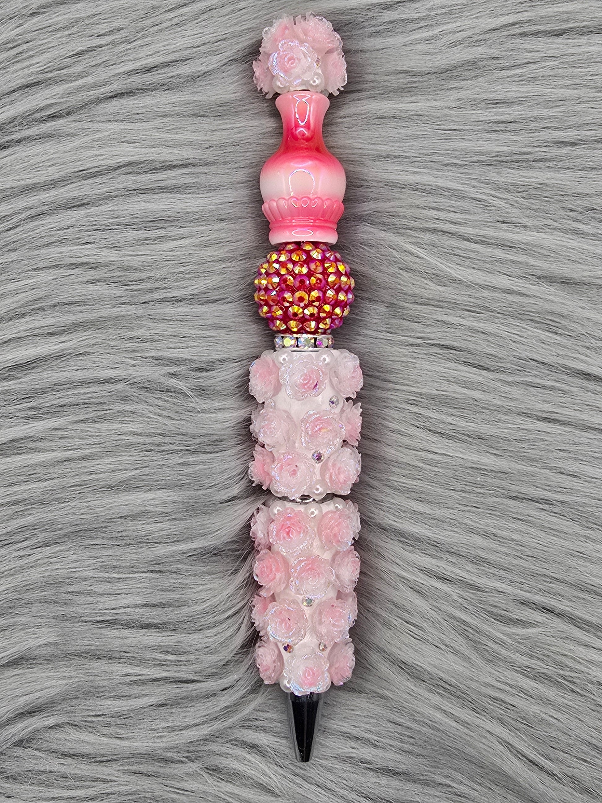 Decorative light red flower pen and a red rhinestone bead with a red ombre vase on top.