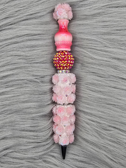 Decorative light red flower pen and a red rhinestone bead with a red ombre vase on top.