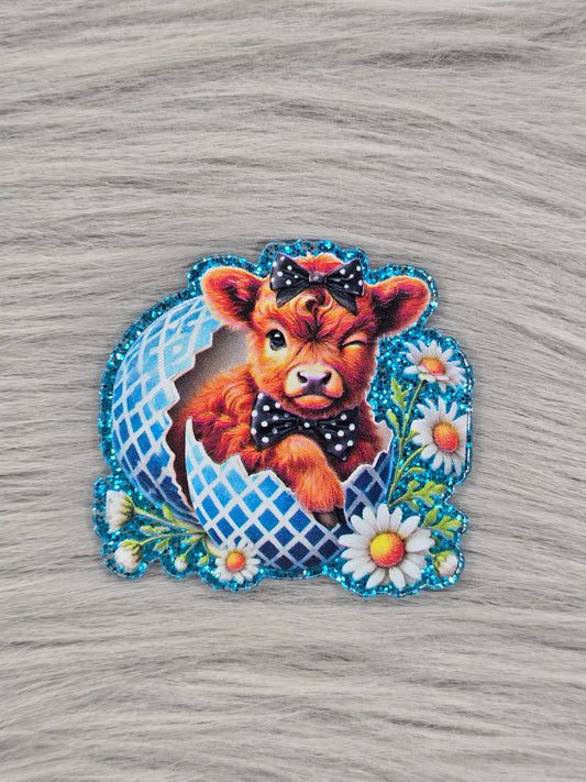 acrylic flatback with a brown cow in a blue strip  egg and white daisy flowers